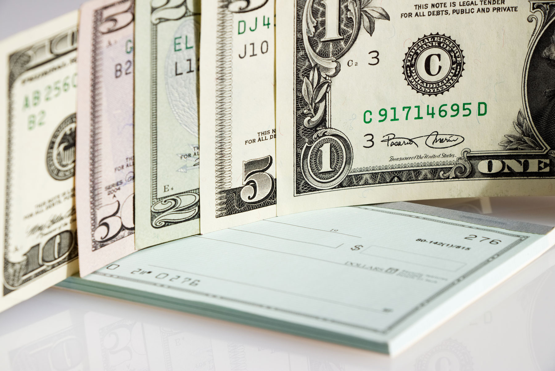A stack of cash and a checkbook