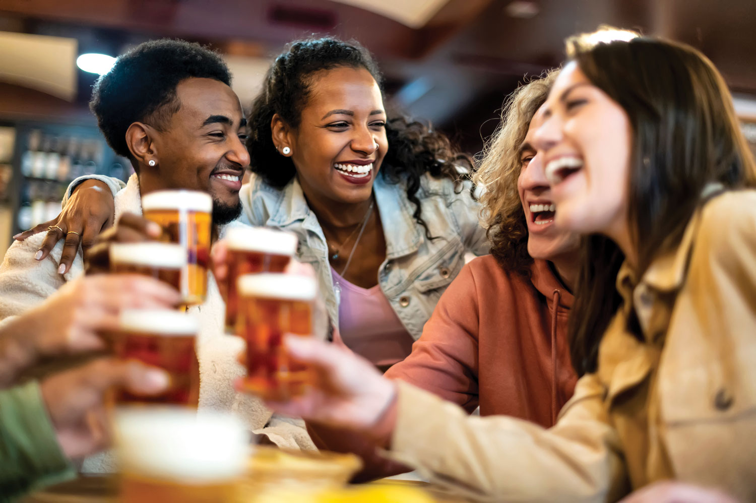 Castaways Bar - Group of happy friends, sharing some laughs over pints of beer